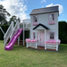Whole Wood Playhouse two story playhouse with slide pricess front