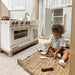 milton-and-goose-essential-kitchen-corner-view-inside-the-house-kid-playing-with-wooden-food